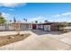 This single-story home has a red door, unique brick accents, and a well-maintained front yard at 1589 Silver Mesa Way, Las Vegas, NV 89169