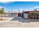 Charming home with a large driveway, red accents, decorative metal work, and desert landscaping at 1589 Silver Mesa Way, Las Vegas, NV 89169