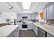Modern kitchen with stainless steel appliances, light gray cabinets, and stylish tile backsplash at 1589 Silver Mesa Way, Las Vegas, NV 89169