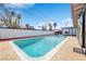 Gorgeous pool with bright blue water surrounded by a large patio with mature trees for privacy at 1589 Silver Mesa Way, Las Vegas, NV 89169
