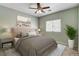 Staged bedroom with a queen size bed, nightstands, and artwork at 177 Shaded Peak St, Henderson, NV 89012