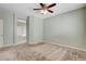 Spacious carpeted bedroom with ceiling fan and ensuite bathroom entrance at 177 Shaded Peak St, Henderson, NV 89012