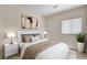 Staged bedroom with a queen size bed, nightstands, and neutral decor at 177 Shaded Peak St, Henderson, NV 89012