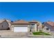 Single-story home with a two-car garage and well-maintained landscaping at 177 Shaded Peak St, Henderson, NV 89012