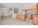 Bright, open kitchen featuring wooden cabinets, stainless steel appliances and island at 177 Shaded Peak St, Henderson, NV 89012