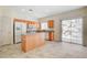 Functional kitchen featuring wood cabinets, white appliances, and a breakfast bar at 177 Shaded Peak St, Henderson, NV 89012