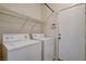 Functional laundry room with washer, dryer, and storage shelf at 177 Shaded Peak St, Henderson, NV 89012