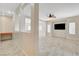 Open living room with tile flooring, ceiling fan and natural light at 177 Shaded Peak St, Henderson, NV 89012