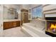 Bathroom featuring a separate shower, soaking tub, a vanity with sink and a fireplace at 2104 Inverness Dr, Henderson, NV 89074