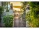 Charming gated entry with lion statues and lush landscaping adding curb appeal at 2104 Inverness Dr, Henderson, NV 89074