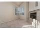 Comfortable living room with a fireplace and bright windows with shutters at 2104 Inverness Dr, Henderson, NV 89074