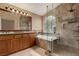 Bathroom features tiled shower and tub, double sinks, and large framed mirror at 2199 Timescape Ct, Las Vegas, NV 89123