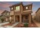 Charming two-story home with stucco exterior, covered porch, and landscaped front yard under a colorful sky at 2199 Timescape Ct, Las Vegas, NV 89123