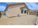 Back of home with rock-landscaped yard, including irrigation cart at 2445 Sturrock Dr, Henderson, NV 89044