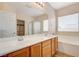 Bathroom features a dual sink vanity, soaking tub, glass shower, and view into the walk-in closet at 2445 Sturrock Dr, Henderson, NV 89044