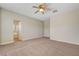 Large bedroom with plush carpet and a ceiling fan, with access to an ensuite bathroom at 2445 Sturrock Dr, Henderson, NV 89044