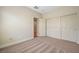 Neutral bedroom featuring carpet flooring, a closet, and an open entry door at 2445 Sturrock Dr, Henderson, NV 89044