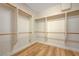 Walk-in closet with custom shelving and wooden rods for optimal organization and storage at 2445 Sturrock Dr, Henderson, NV 89044