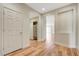 Inviting entryway with wood-look flooring, a coat closet, and an open view to the living area at 2445 Sturrock Dr, Henderson, NV 89044