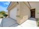 Close-up of a home's exterior showcasing a front door and two-car garage with the address number at 2445 Sturrock Dr, Henderson, NV 89044