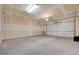 Spacious two car garage with unfinished drywall and concrete flooring at 2445 Sturrock Dr, Henderson, NV 89044