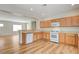 Open kitchen with wood cabinets, plenty of counter space, and an adjacent view into the living area at 2445 Sturrock Dr, Henderson, NV 89044