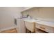 Functional laundry room showcasing a sink, shelving, and a modern washing machine at 2445 Sturrock Dr, Henderson, NV 89044