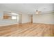 Open floor plan living room featuring wood-look floors and an adjacent kitchen at 2445 Sturrock Dr, Henderson, NV 89044
