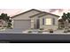 Charming single-story home showcasing desert landscaping, a two-car garage, and a welcoming covered entryway at 2607 Regency Cove Ct # Lot 11, Las Vegas, NV 89121