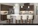 Modern kitchen boasts stainless steel appliances, dark wood cabinetry, and a large center island with barstool seating at 2607 Regency Cove Ct # Lot 11, Las Vegas, NV 89121