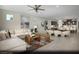 Open-concept living area featuring a plush sectional sofa, stylish decor, and seamless flow into the dining and kitchen at 2607 Regency Cove Ct # Lot 11, Las Vegas, NV 89121