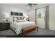 Inviting primary bedroom showcasing a king-size bed, stylish decor, and a large window with outdoor views at 2607 Regency Cove Ct # Lot 11, Las Vegas, NV 89121