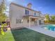 Backyard view of the house highlighting the patio, artificial grass, and inground pool at 2732 Dune Cove Rd, Las Vegas, NV 89117