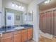 Bathroom featuring a single vanity with oak cabinets and tile floors at 2732 Dune Cove Rd, Las Vegas, NV 89117