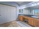Bathroom with tile floor, dual sinks, black countertops, and plenty of storage at 2732 Dune Cove Rd, Las Vegas, NV 89117