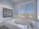 Sunlit bathroom features an oversized tub with tile surround and window at 2732 Dune Cove Rd, Las Vegas, NV 89117