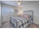 Comfortable bedroom featuring a large window with plantation shutters and a queen-sized bed at 2732 Dune Cove Rd, Las Vegas, NV 89117