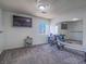 Carpeted Bonus Room with large mirror, mounted TV, and workout equipment at 2732 Dune Cove Rd, Las Vegas, NV 89117