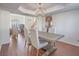 Elegant dining room with a modern chandelier and a view of the living room and entryway at 2732 Dune Cove Rd, Las Vegas, NV 89117