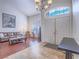 A bright entryway with a soaring ceiling, a front double door, and art, creating a grand welcome at 2732 Dune Cove Rd, Las Vegas, NV 89117