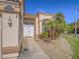 Close-up view of the home's entrance, featuring double doors, stone landscaping, and a well-manicured lawn at 2732 Dune Cove Rd, Las Vegas, NV 89117