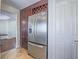 Kitchen view of stainless refrigerator, wine rack, and tile flooring at 2732 Dune Cove Rd, Las Vegas, NV 89117