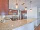 Open kitchen with stainless steel appliances, granite countertops, and pendant lighting over the breakfast bar at 2732 Dune Cove Rd, Las Vegas, NV 89117