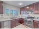 Bright kitchen featuring stainless steel appliances, granite countertops, and ample natural light from the window at 2732 Dune Cove Rd, Las Vegas, NV 89117