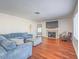 Cozy living room with hardwood floors, fireplace, and comfortable seating at 2732 Dune Cove Rd, Las Vegas, NV 89117