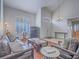 Inviting living room with a vaulted ceiling, plantation shutters, and comfortable seating, offering a cozy atmosphere at 2732 Dune Cove Rd, Las Vegas, NV 89117