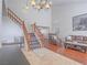 Open concept living room features vaulted ceilings, hardwood floors, and staircase at 2732 Dune Cove Rd, Las Vegas, NV 89117