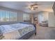 Serene main bedroom with sitting area, fireplace, and plantation shutters at 2732 Dune Cove Rd, Las Vegas, NV 89117