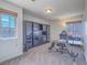 Office area with windows, carpet, glass table, built-in shelving, and unique chair at 2732 Dune Cove Rd, Las Vegas, NV 89117