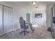 A home office features a glass desk with a custom pipe base and a rolling office chair at 2732 Dune Cove Rd, Las Vegas, NV 89117